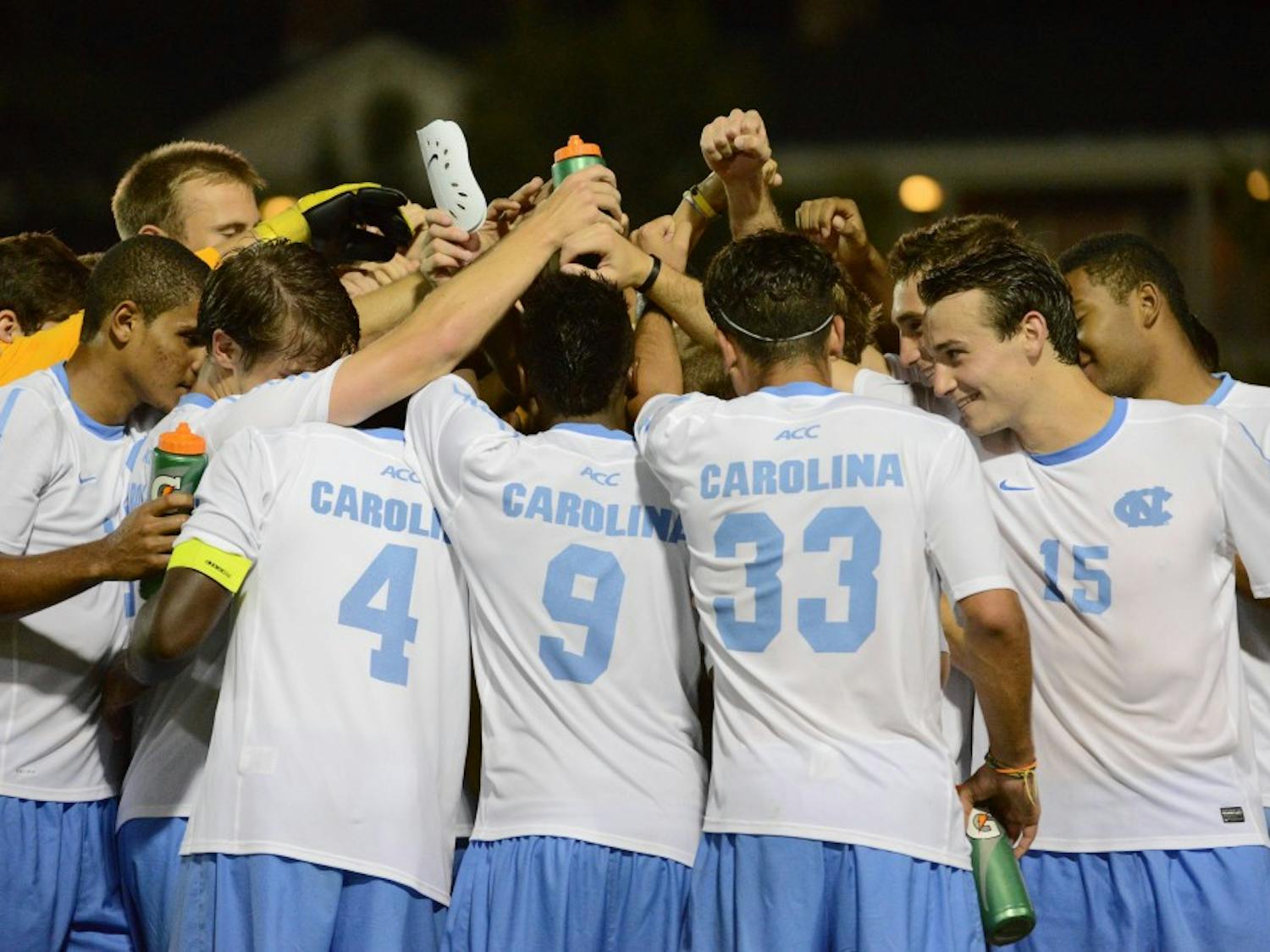 UNC huddles after defeating Monmouth 1-0 in the second overtime period.