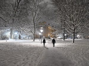 People walk through snowy North Campus on a Wednesday night in 2018.