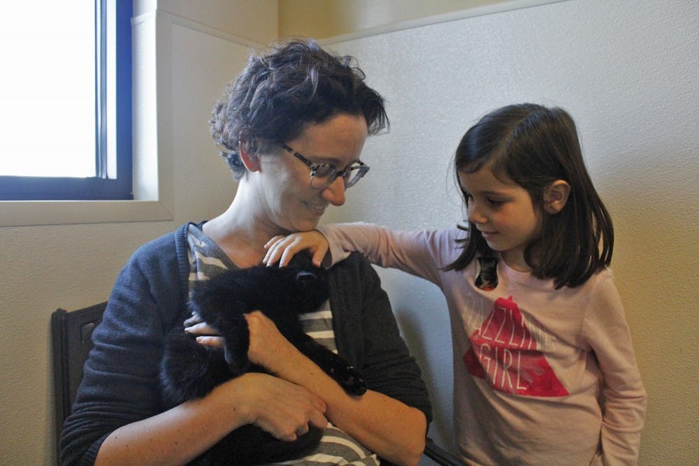 Allison and her daughter Carmen meet their new cat Cosmo for the first time. 