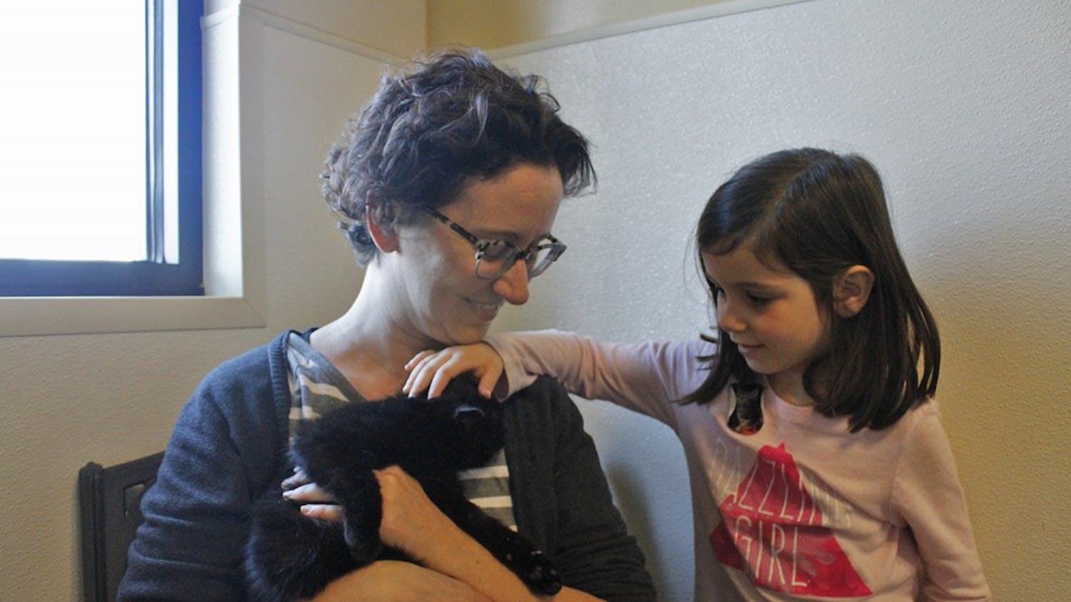 Allison and her daughter Carmen meet their new cat Cosmo for the first time. 