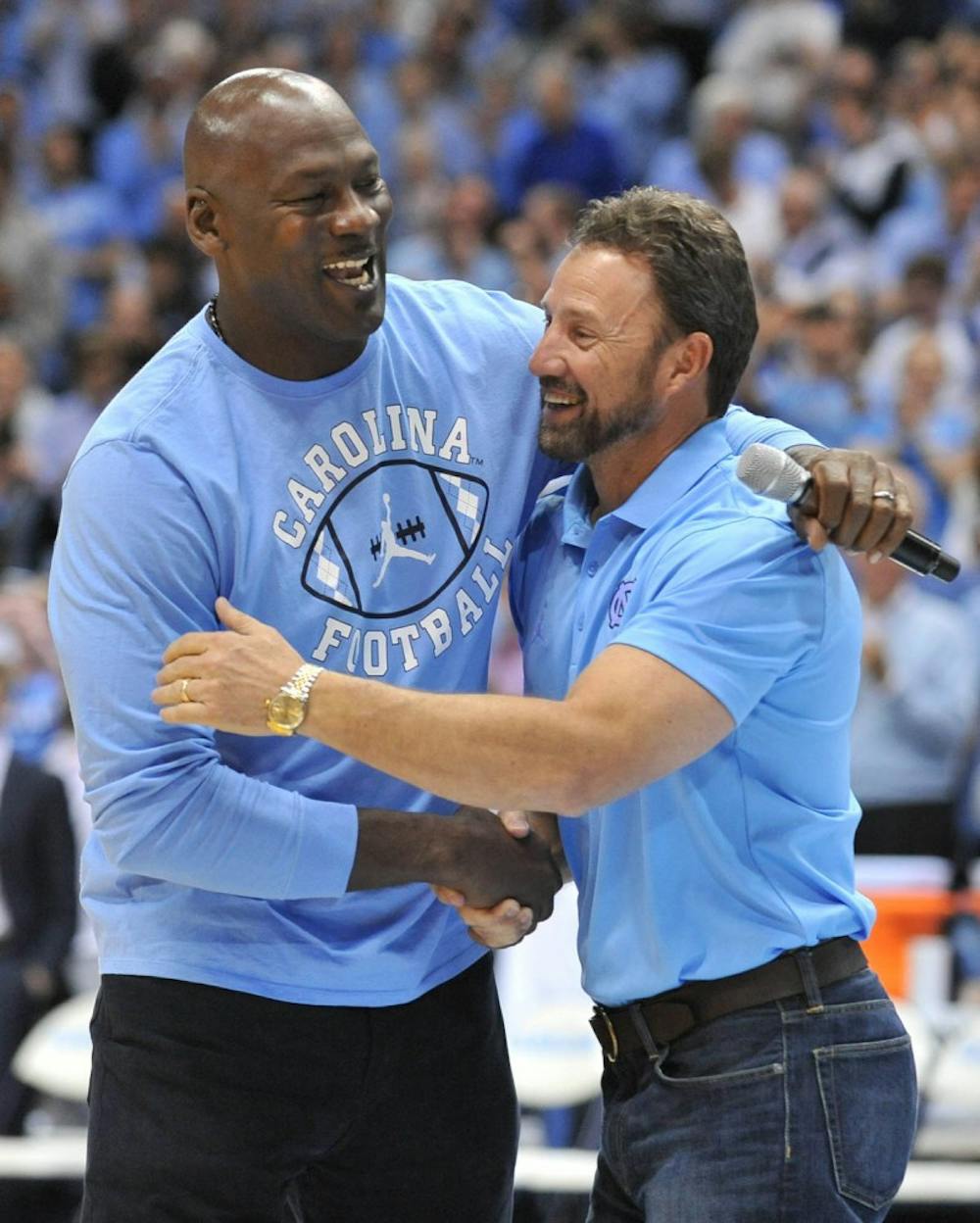 Former North Carolina basketball player and NBA Hall of Fame inductee Michael Jordan shakes hand with North Carolina football coach Larry Fedora at halftime of Saturday night's game. Jordan made an appearance to announce a new partnership between the Jordan brand and the North&nbsp;Carolina football team starting in the 2017 season.