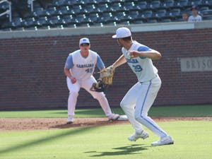 Junior pitcher Brandon Schaeffer (39) throws the ball to first baseman Hunter Stokely (1) to get a Wake Forest runner out. UNC won 12-3 versus Wake Forest at home on Saturday, May 14, 2022, in the second game of the three game series.