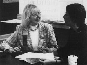 DTH Archive. Irene Briggaman (left) laughs with Chrissy Beck at the Chapel Hill Chamber of Commerce while discussing the 2005 membership drive. Photo by Chris Fields.