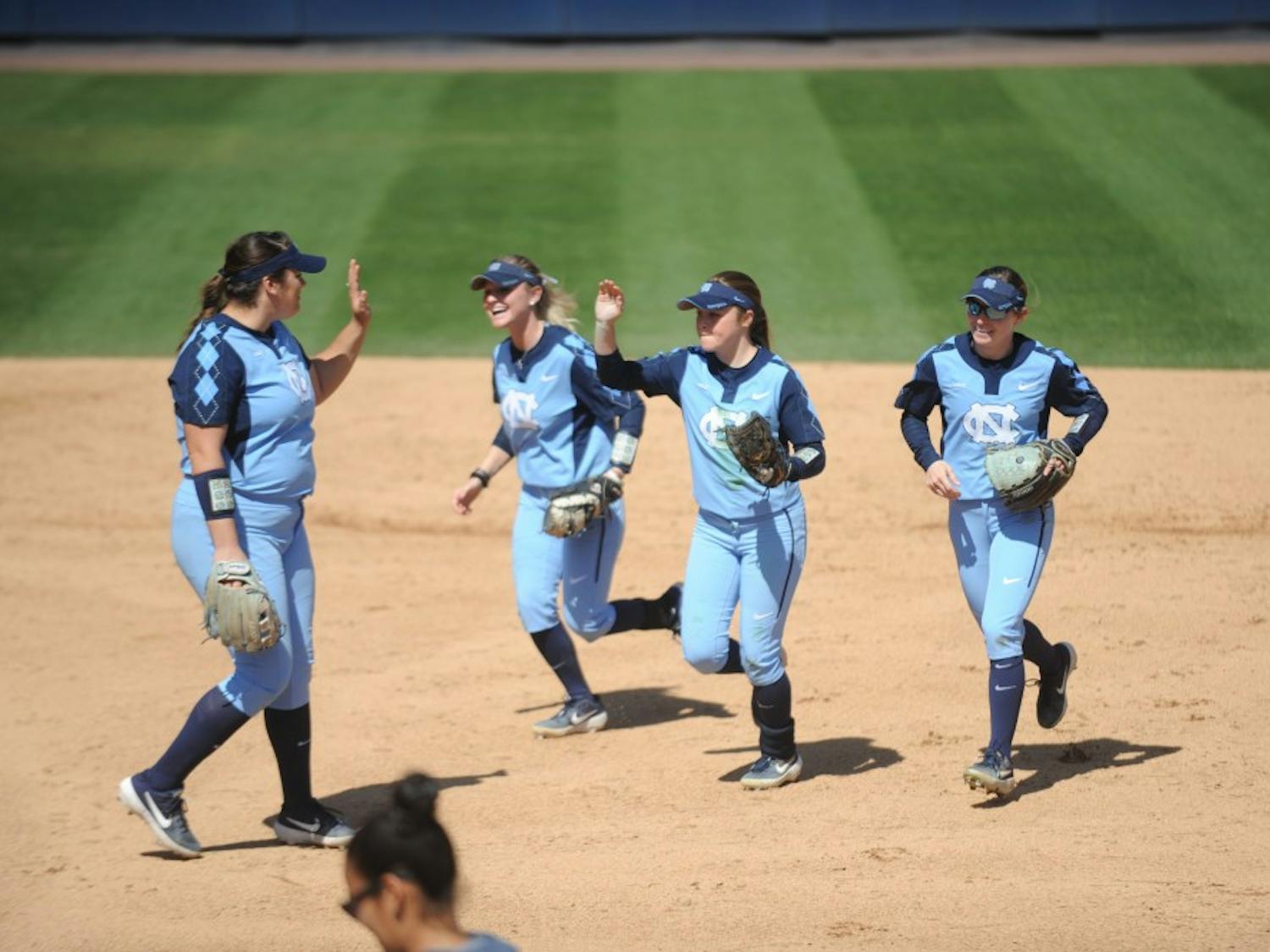 Players celebrate during UNC's Softball game vs. Georgia Tech on Sunday, Mar. 24. UNC lost the game 3-2.