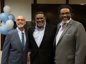Dean Raul Reis of the UNC Hussman School of Journalism and Media, Franklin McCain Jr., and UNC Professor Carl Kenny pose together in the Freedom Forum Conference Center on Tuesday, Jan. 17, 2023.