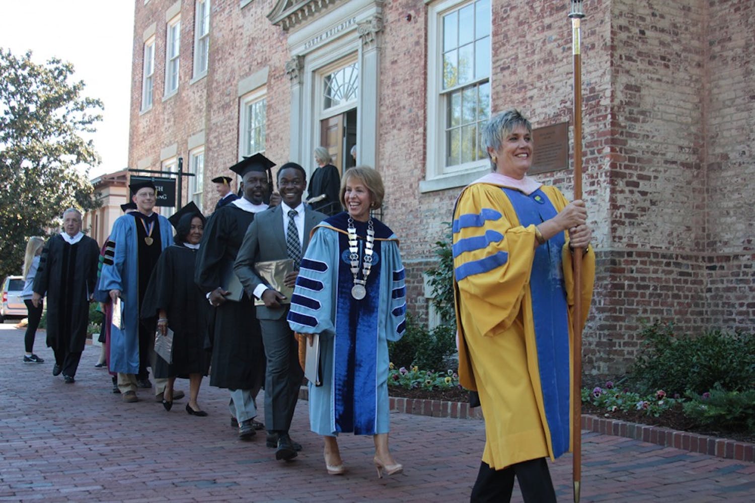 The University Day procession, including Chancellor Carol Folt and Student Body President Bradley Opere, makes its way from South Building to Memorial Hall.