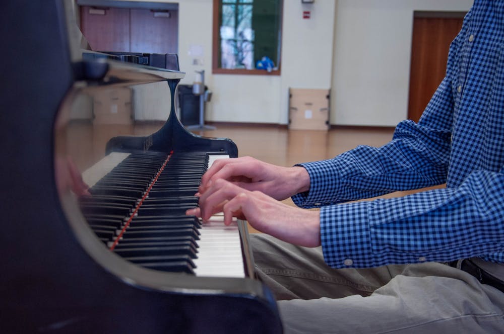 Alex McKeveny, music major, plays the piano in the Kenan Music Building Rehearsal Room on March 21, 2021. The UNC Advanced Composition class (MUSC 266) collaborated with an animation class at NC State to produce animated videos of original music pieces students wrote.