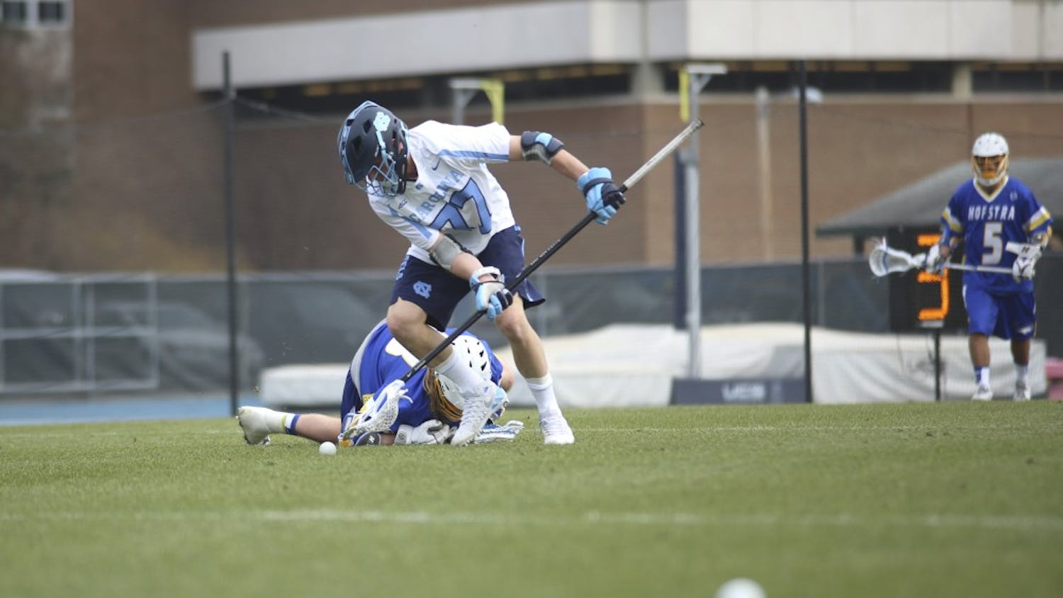 UNC defenseman Zach Powers (77) goes for the ball Saturday afternoon against Hofstra. The Tar Heels fell 10-5. 