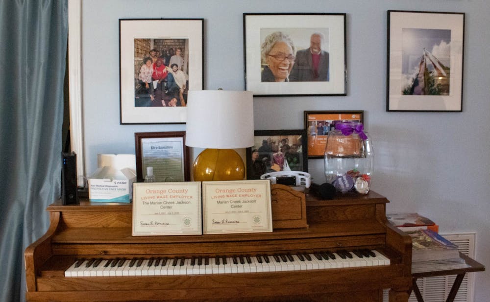<p>A piano and photos on display at The Jackson Center on Monday, Feb. 20, 2023.</p>