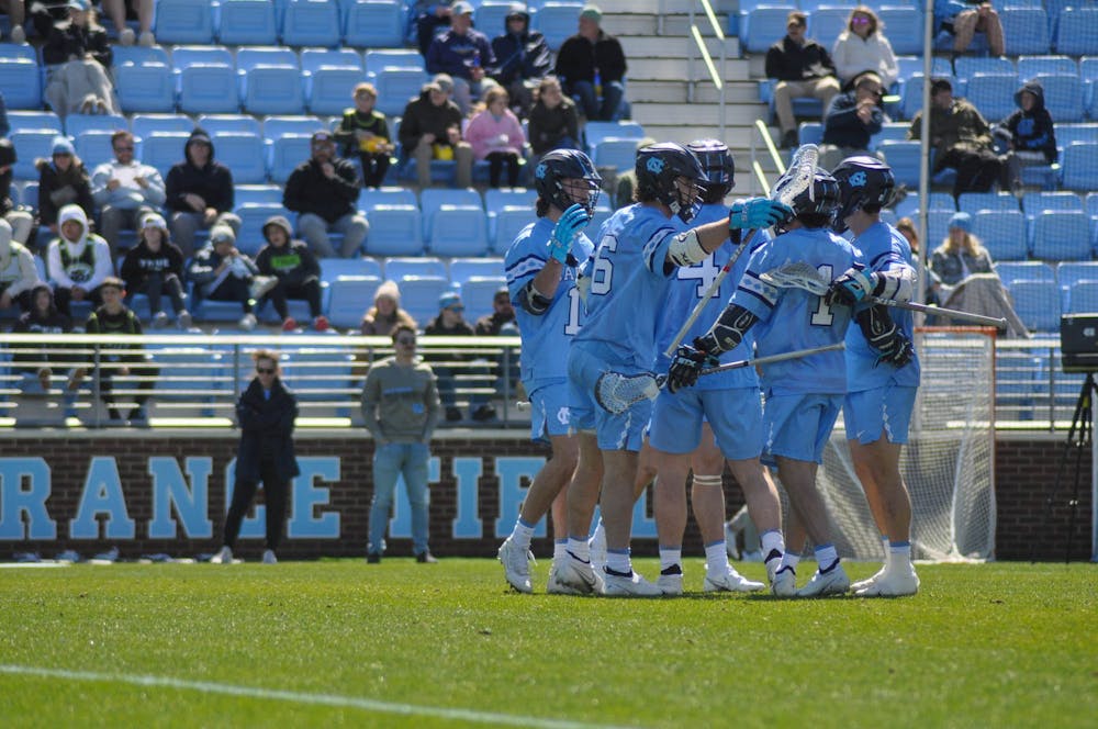 <p>The UNC men's lacrosse team embraces each other after scoring a goal during the game against Brown at Dorrance Field on Saturday, March 11, 2023. UNC beat Brown 19-6.</p>