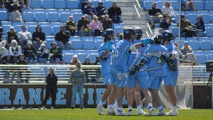 The UNC men's lacrosse team embraces each other after scoring a goal during the game against Brown at Dorrance Field on Saturday, March 11, 2023. UNC beat Brown 19-6.