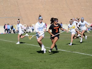 Midfielder Maggie Bill (22) plays defense against Florida during the women's lacrosse game on Saturday in Kenan Stadium.