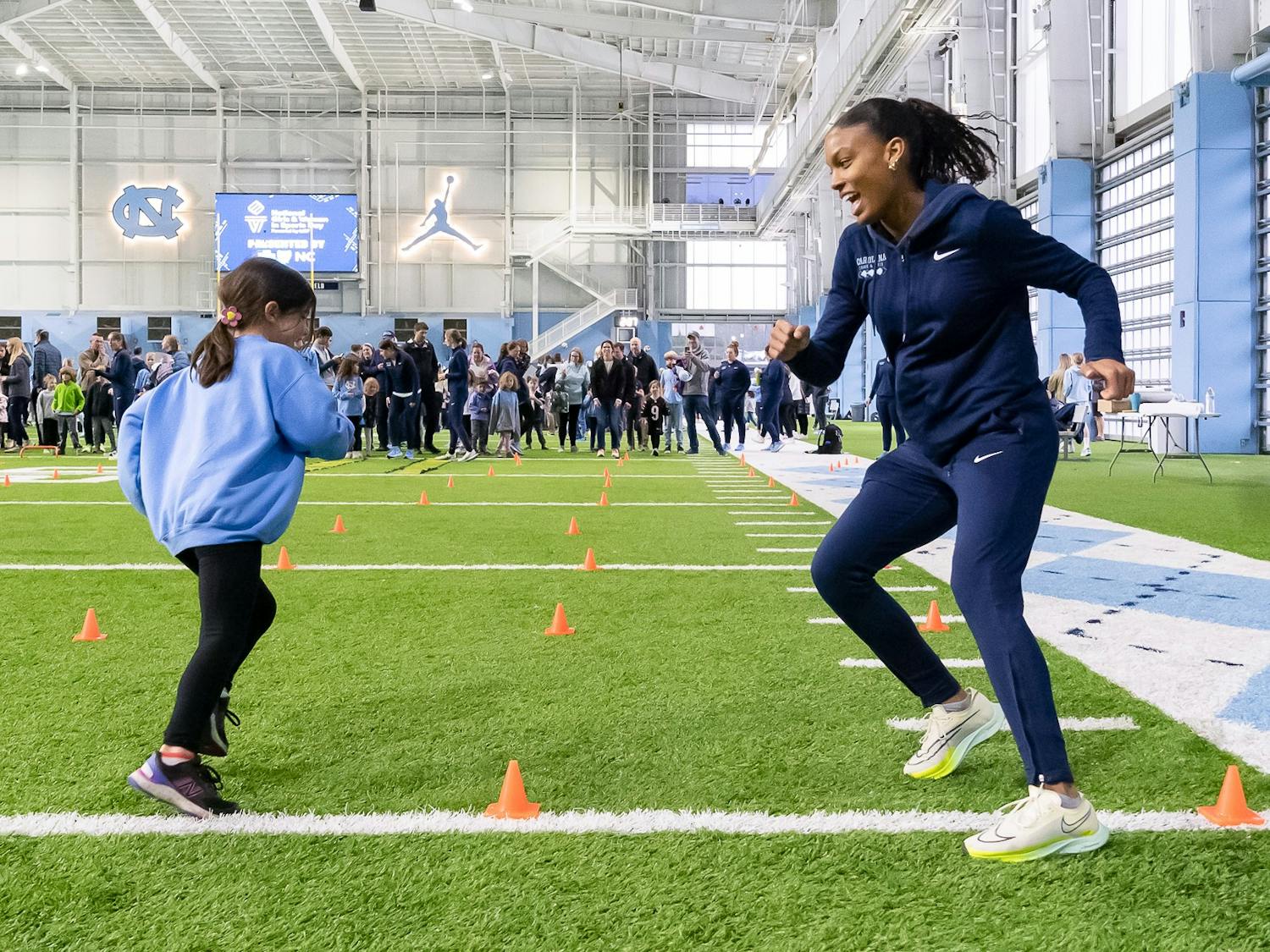 UNC junior high jumper Sydney Banks races Emma Walters at the National Girls & Women in Sports Day event held at the Bill Koman Practice on Sunday, Jan. 22, 2023.