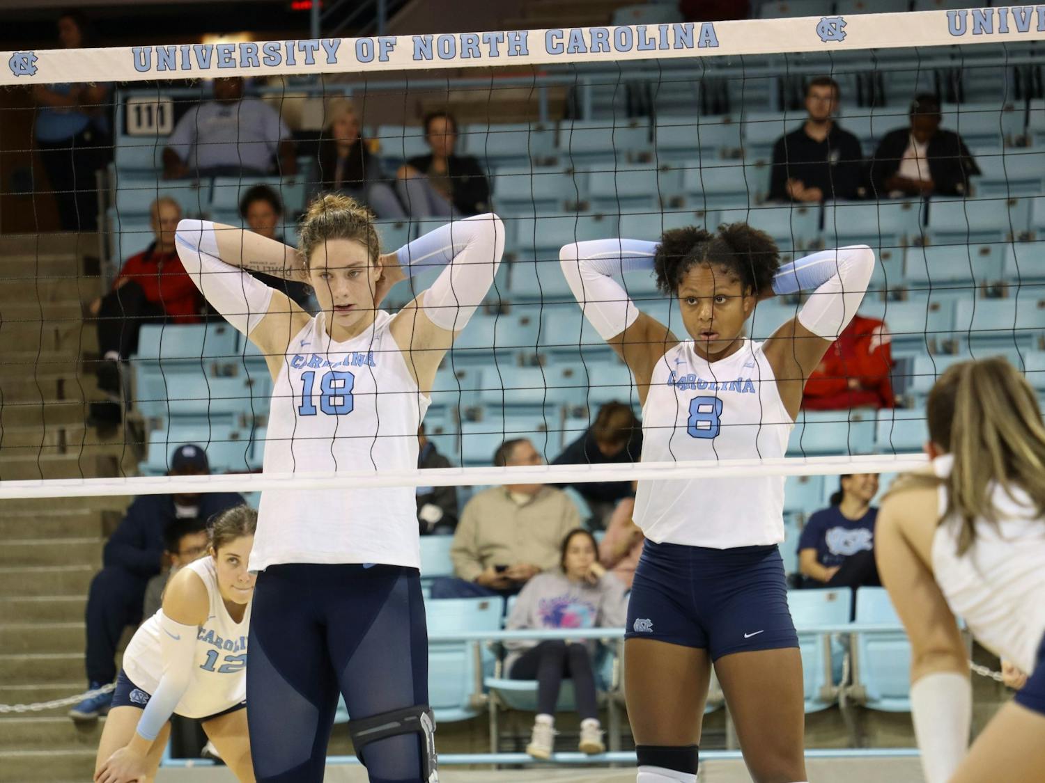 UNC freshman middle hitter Liv Mogridge (18) and senior middle hitter Skyy Howard (8) prepare for the next set during the volleyball match against Georgia Tech on Friday, Oct. 28, 2022 at Carmichael Arena. UNC lost 3-1.