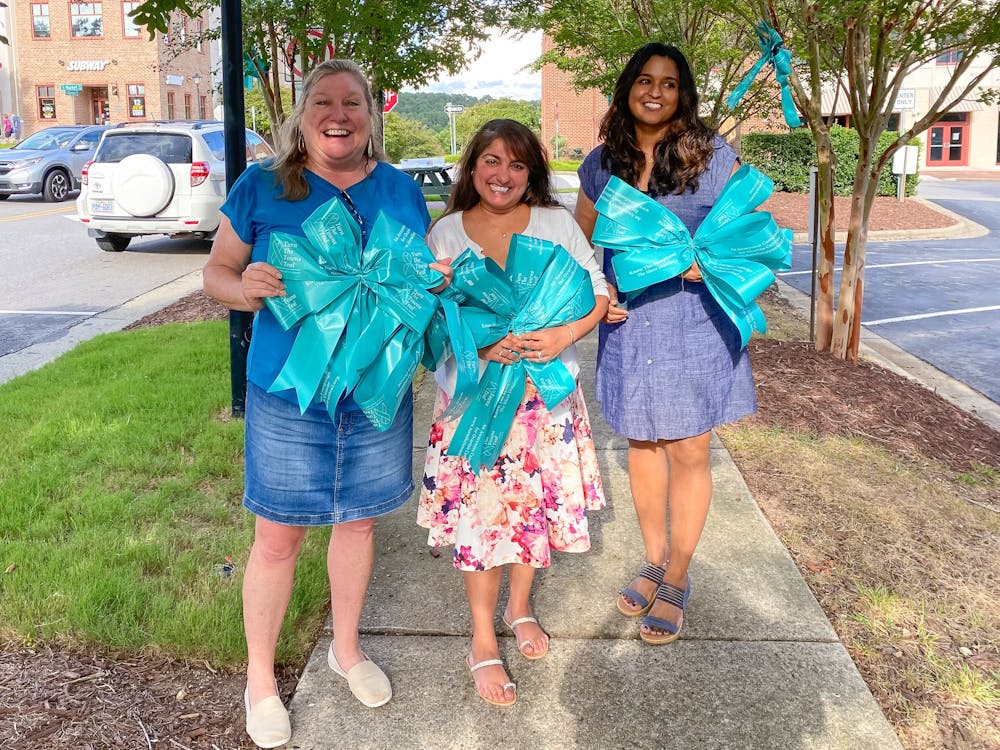 Southern Village resident Meghan Maynard, who led "Turn the Town Teal," poses with her friends Pavita Derebail and Jaydeep Lamba on Market Street on Sept. 11, 2022. Maynard, on the left, led the event in honor of her late mother and her late best friend, both of whom had passed from ovarian cancer.
Photo Courtesy of Meghan Maynard.
