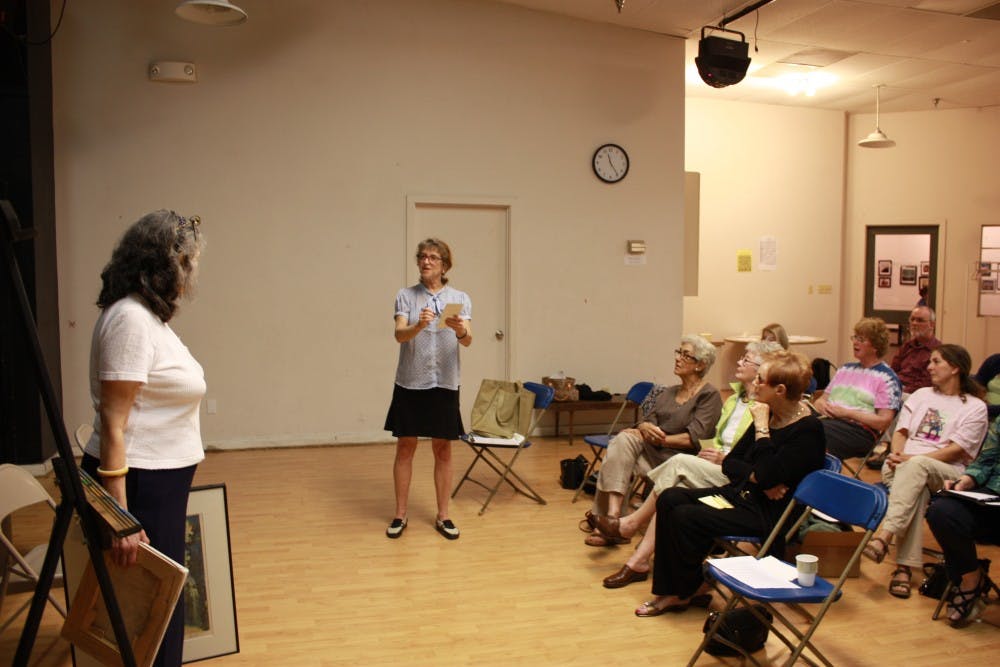 	<p>Joy Javits (center) helps local artists in a workshop in The ArtsCenter in Carrboro. The event known as &#8220;Artists&#8217; Salon,&#8221; brings artists together in order to work on their art. Friday&#8217;s theme was &#8220;How to Present Your Art.&#8221;</p>