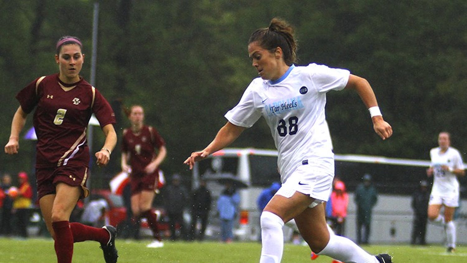 The women's soccer team defeated Boston College on a rainy Friday afternoon, Oct. 2, with a score of 2-0. Alexa Newfield (88) pushes the ball up the field.
