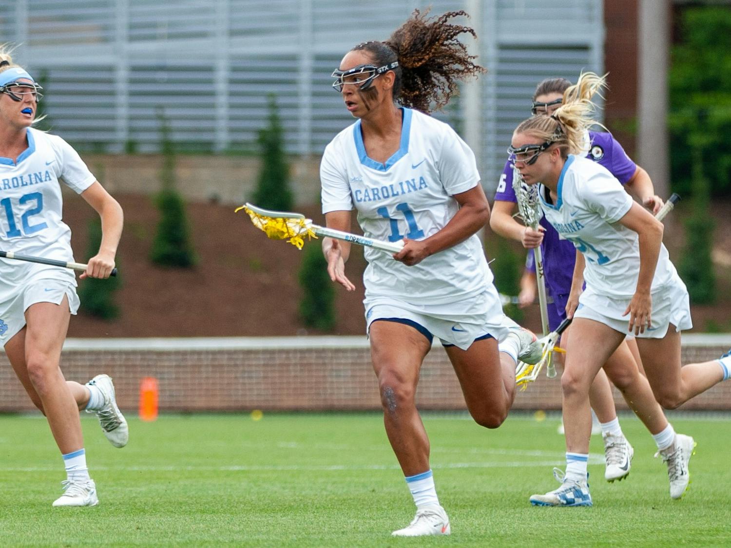 UNC senior defender Kayla Wood (11) runs with the ball at the second round of the NCAA tournament against James Madison on Sunday May 16, 2021 at the Dorrance Field in Chapel Hill. The Tar Heels won 14-9.