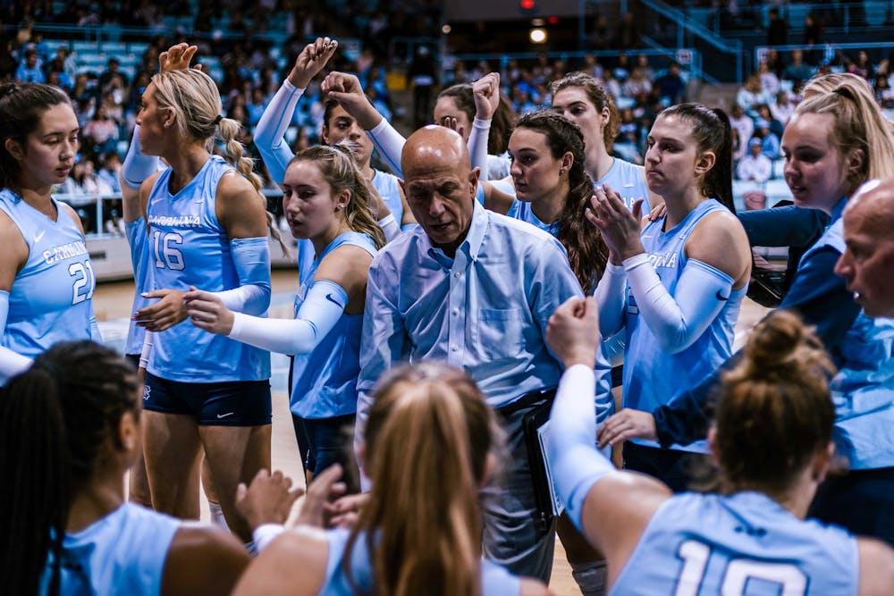 UNC head coach Joe Sagula and the team are pictured during a timeout in the third set, attempting to stave off a straight set loss in the volleyball match against Louisville on Sunday, Nov. 13, 2022. UNC fell 3-0 to Louisville.