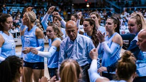 UNC head coach Joe Sagula and the team are pictured during a volleyball match against Louisville on Sunday, Nov. 13, 2022. Sagula announced his retirement in January after 33 years at the helm of UNC's program.