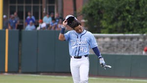 Redshirt junior right fielder Angel Zarate (40) removes his helmet as he walks off the field. UNC lost 3-4 against Arkansas at home in the NCAA Super Regionals on Sunday, June 12, 2022.