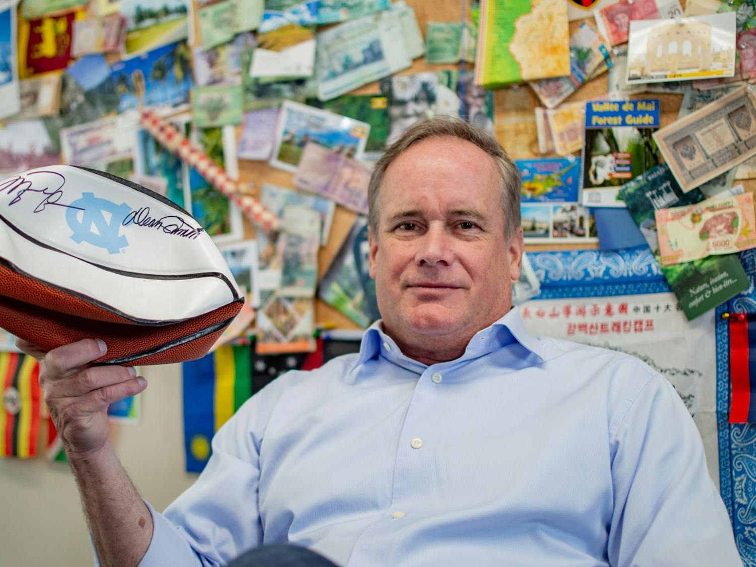Entrepreneur and UNC Professor of the Practice of Strategy and Entrepreneurship, Jim Kitchen, holds his Michael Jordan and Dean Smith signed basketball in his office on Franklin Street in Chapel Hill on March 22, 2022, exactly one week before he travels to space. The basketball is one of the items he's planning on bringing to space.
