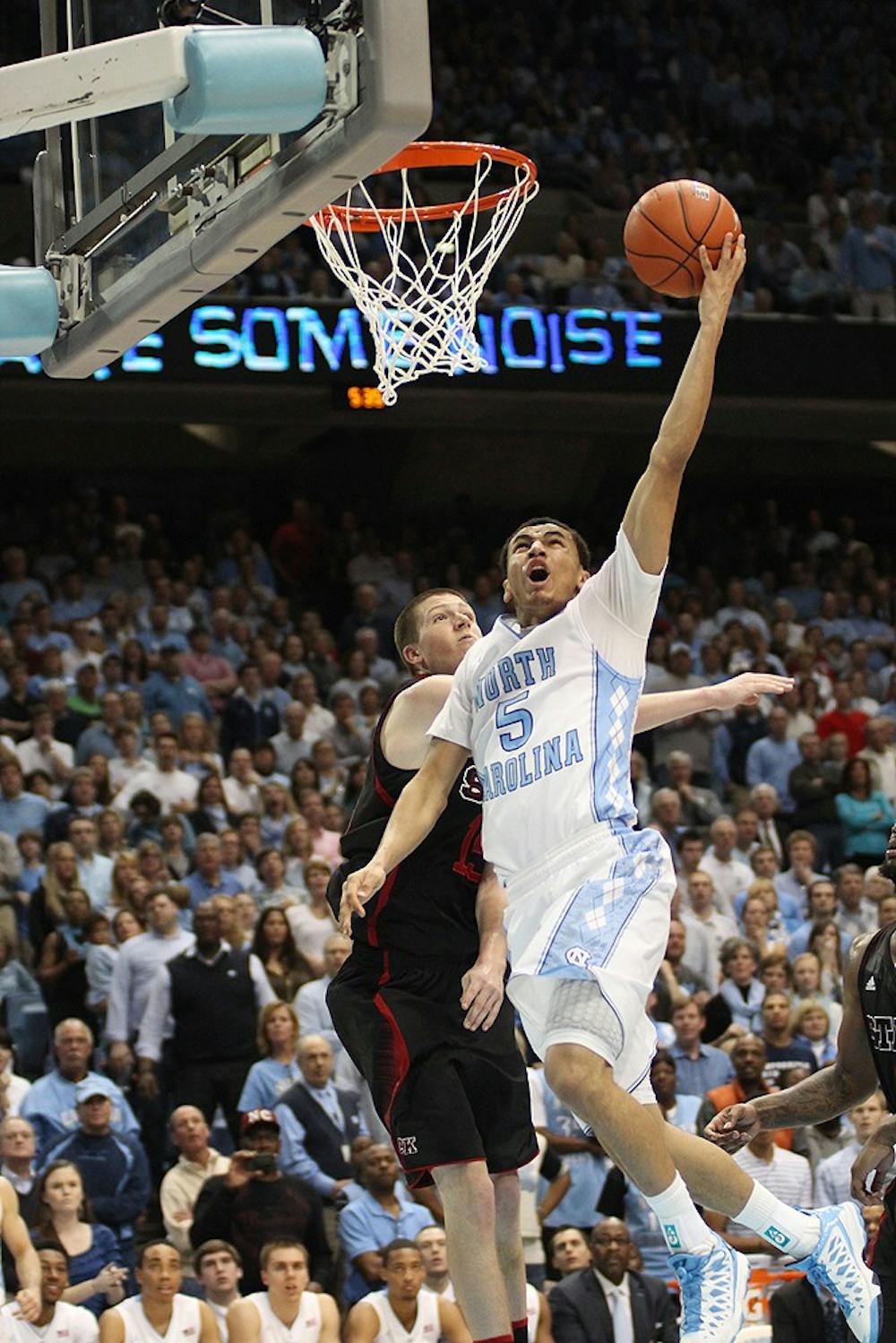 	Marcus Paige blows by Scott Wood on the way to the basket during the second half of Saturday’s game. Paige scored 14 points, dished out 11 assists and committed no turnovers against N.C. State. 