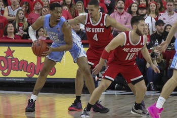 UNC Junior forward Garrison Brooks (15) looks to pass the ball in the game against N.C. State on Monday, Jan. 27, 2020 at the PNC Arena in Raleigh, N.C.&nbsp;