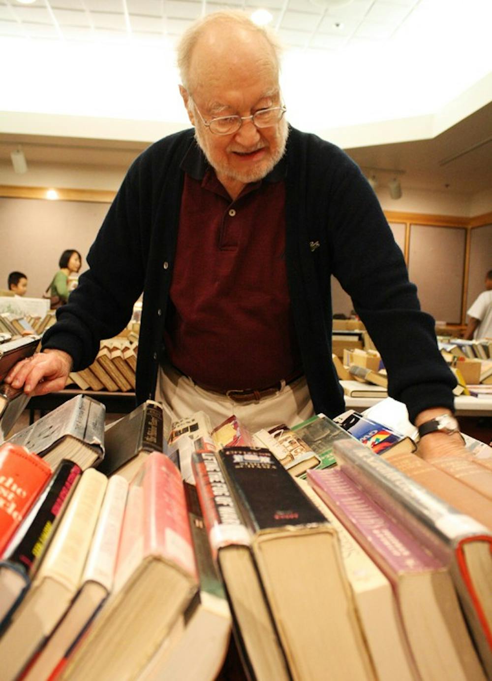 Former Wilson Library librarian and UNC faculty member Ray Carpenter of Chapel Hill organizes books at the sale on Sunday.