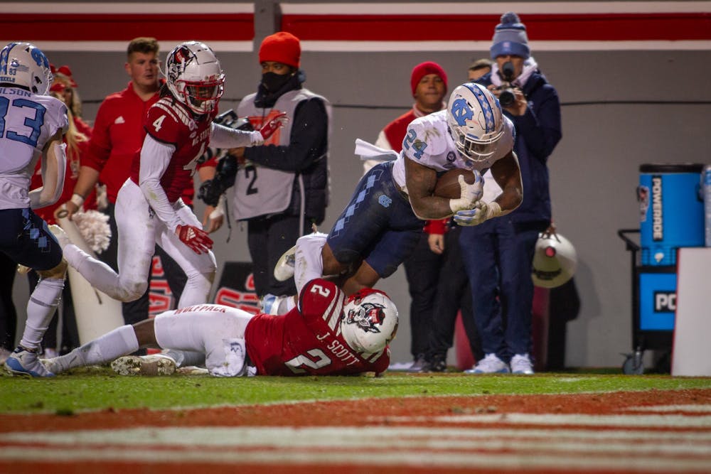 UNC senior running back British Brooks (24) catches a long pass during the Tar Heels' football game against the N.C. State Wolfpack at Carter Finley Stadium in Raleigh, NC, on Friday, Nov. 26, 2021. UNC lost 34-30.