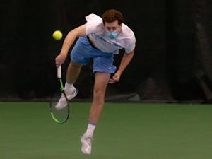 Senior Henry Lieberman serves the ball during a match against Bucknell University at the Cone-Kenfield Tennis Center on Sunday, Jan. 23, 2022. The Heels won 7-0.