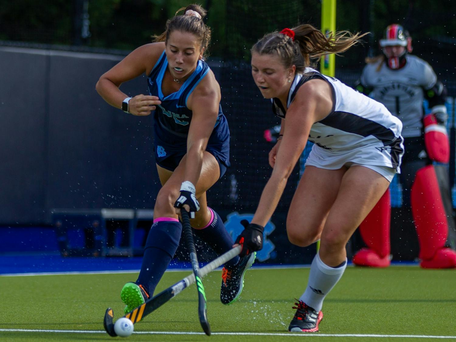 First-year forward Kennedy Cliggett (36) fights for the ball at the field hockey game against Louisville on Oct. 22 at the Karen Shelton Stadium. UNC lost 2-3 in overtime.