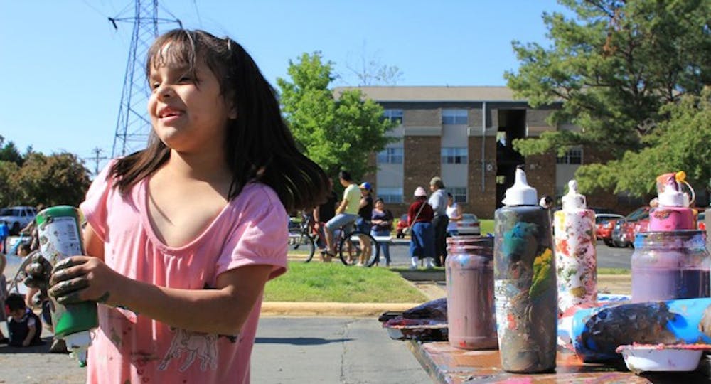 	<p>A young girl paints at Abbey Court apartments. With a grant from Chapel Hill, local artists are helping give a voice to residents in the Triangle.<br />
Photo courtesy of Lincoln Hancock</p>