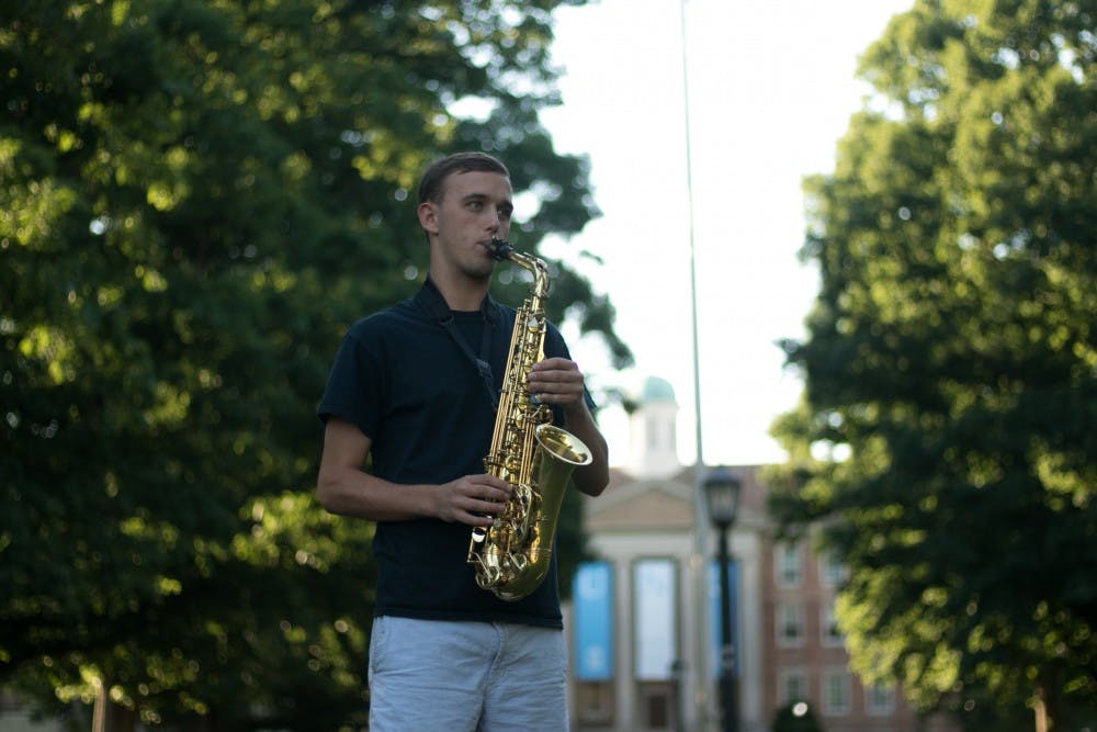 Bryce Lapping, senior political science and journalism major, plays the alto saxophone with the Marching Tar Heels.