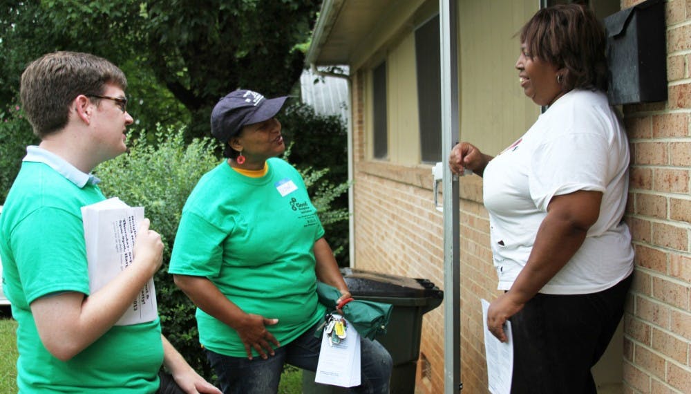 Linda Smith meets Delores Bailey, executive director of Empowerment Incorporated, and Lee Storrow, Chapel Hill Town Council member, as part of the Northside walk to encourage getting to know neighbors. 