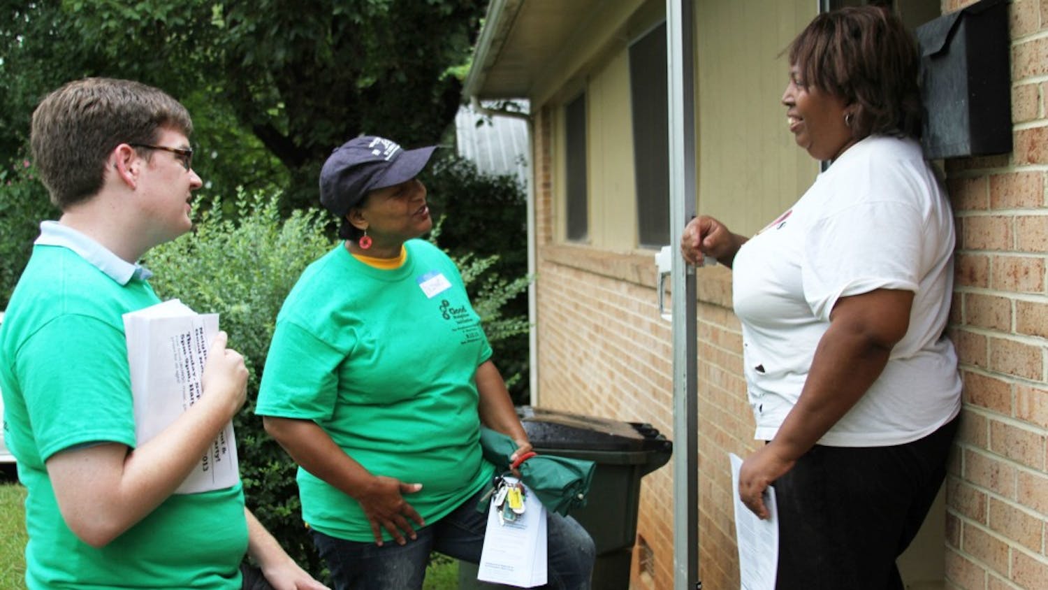 Linda Smith meets Delores Bailey, executive director of Empowerment Incorporated, and Lee Storrow, Chapel Hill Town Council member, as part of the Northside walk to encourage getting to know neighbors. 