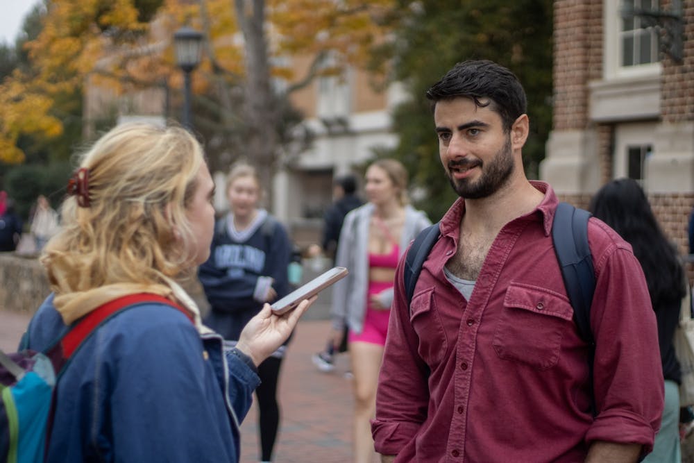 <p>UNC first-year Lauren Rhodes interviews Daniel Goldstein, a junior exercise science major, in the Pit about what he is prioritizing this election cycle on Oct. 26, 2022.</p>