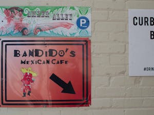 A sign on Franklin Street directs pedestrians down to Bandidos Mexican Cafe on Feb. 4, 2021. After struggling with financial stress created by the COVID-19 pandemic, Chapel Hill restaurant Bandido’s started a GoFundMe campaign last month to supplement its lull in foot traffic.&nbsp;