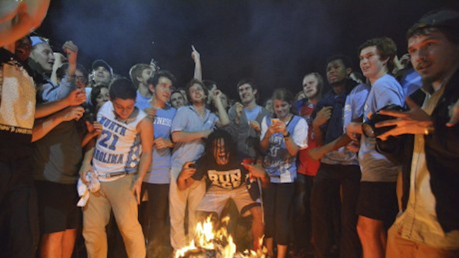 Excited fans jump over a bonfire on Franklin Street after North Carolina beat Duke in men’s basketball two years ago.