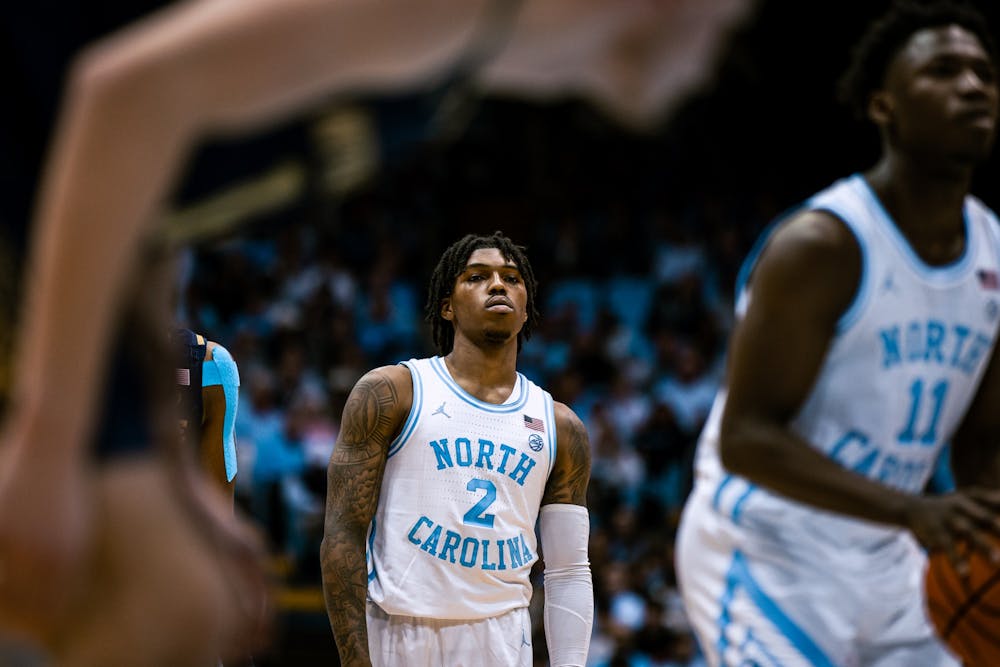 UNC junior Caleb Love (2) watches sophomore teammate D'Marco Dunn (11) take a free throw at the men's basketball game against Notre Dame on Saturday, Jan. 7, 2023. UNC won 81-64 at the Dean Smith Center.