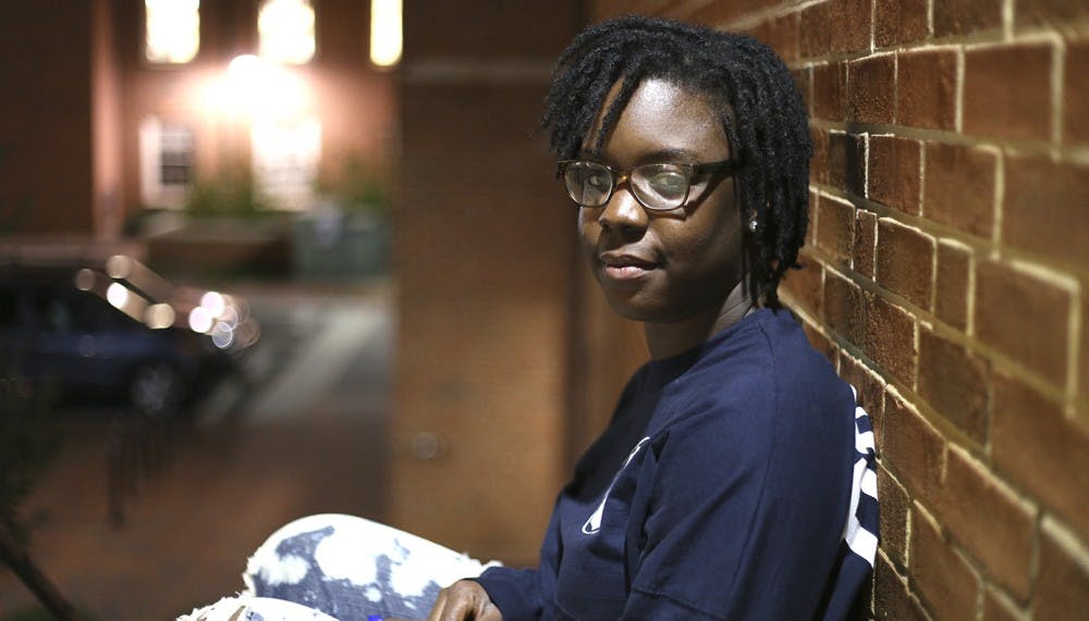 Mishana Sturdivant, the president of Sigma Gamma Rho Sorority, Inc., and a communications and journalism major from Winston Salem, sits outside of Coker Hall on Monday evening.