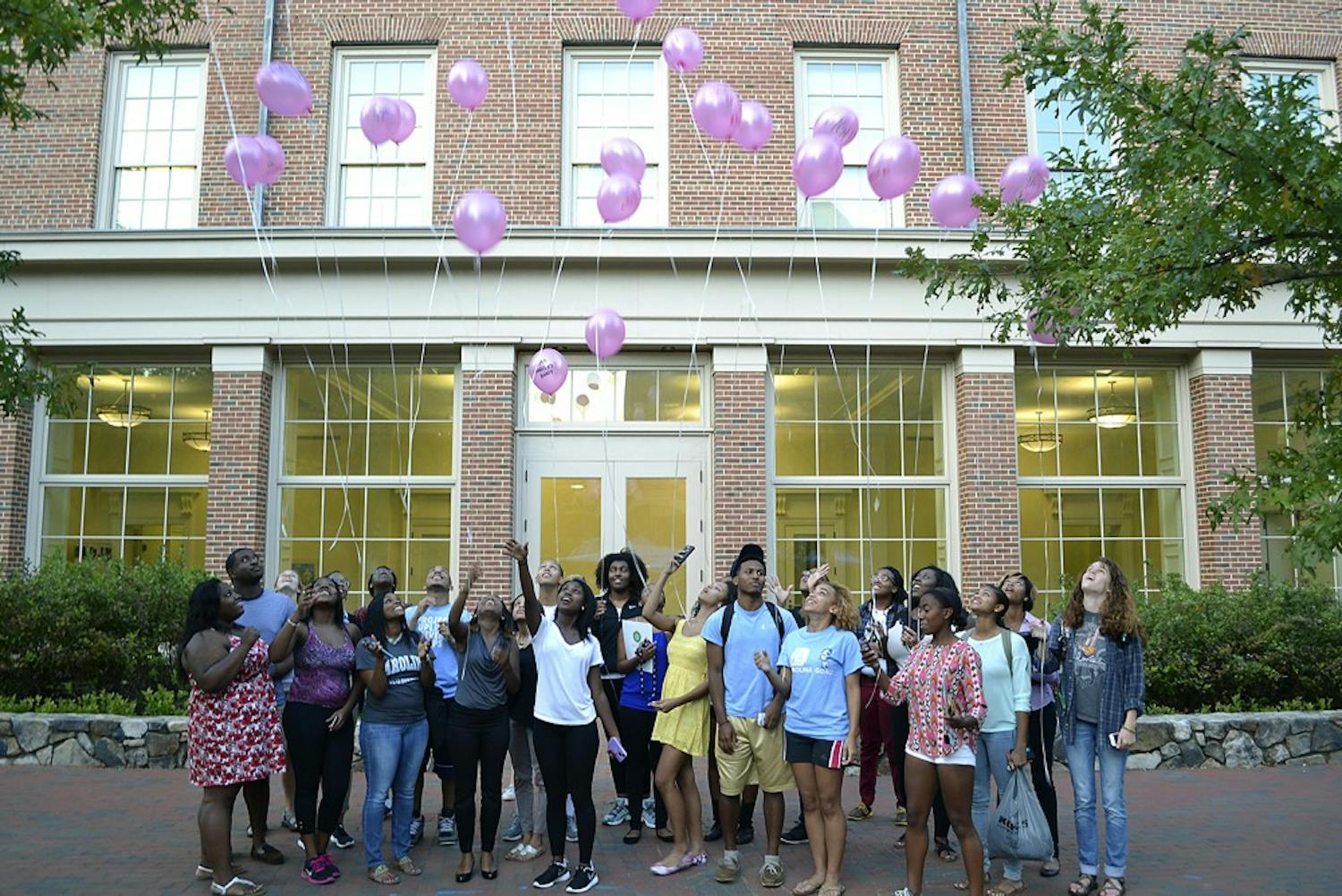 Members of the Black Student Movement release balloons in honor of Breast Cancer Awareness month Wednesday afternoon in the SASB courtyard.  Members wrote message such as "stay strong" and "just keep fighting" on the balloons to be released in the sky.