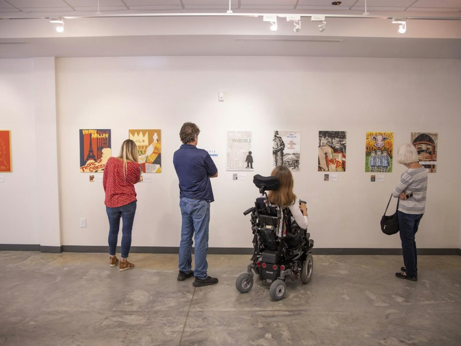 The 2014 and 2015 winners of the Banned Books art competition inspire awe in several visitors to the installation currently being hosted on 109 E. Franklin St. on Monday, September 16, 2019. &nbsp;The exhibit features different artists’s expressions of famous banned books in a gallery put together by Chapel Hill Public Library in honor of Banned Books Week.&nbsp;
