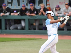UNC sophomore outfielder Justice Thompson (20) offers at a pitch during the Tar Heels' game against East Carolina University at Boshamer Stadium on March 23, 2021. The Tar Heels defeated the Pirates 8-1.