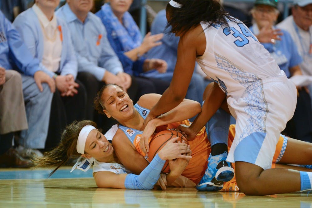 UNC's Jessica Washington (24) and Xylina McDaniel (34) tie up a Tennessee player.