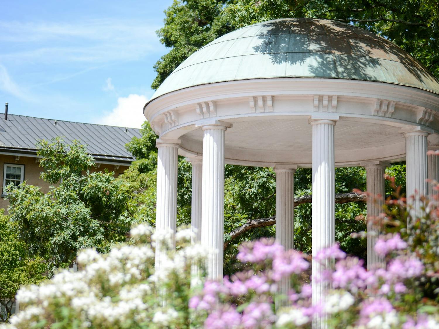 The Old Well, complimented by late summer flora, stands tall on August 7, 2022. UNC's Class of 2026 makes their way on campus, guided by the advice and actions of upperclassmen.