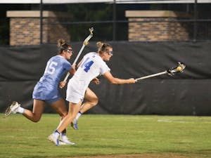 Duke attacker, Olivia Jenner (14), and UNC defender, Charlotte Sofield (15), fight for possession of the ball.   No.3 UNC defeated No.13 Duke 19-5 on Saturday, April 20, 2019 at Koskinen Stadium at Duke University. UNC will enter the upcoming ACC Tournament as a No.2 seed.