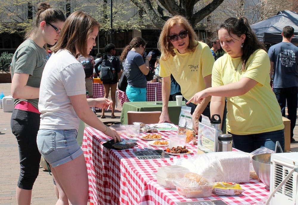 <p>Lydia Ippolito and her daughter Carina Ippolito offer samples from their Delight Soy stand at the Fair Local Organic Food spring farmer’s market Thursday.</p>