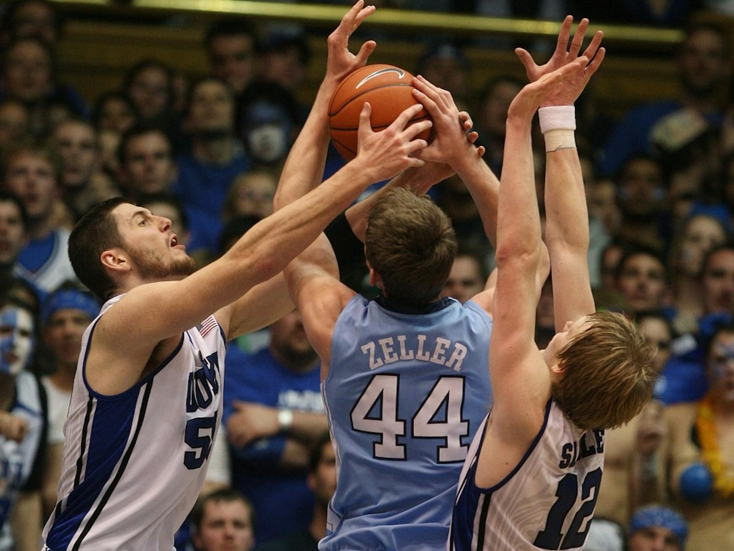 Duke's Brian Zoubek (55) and Kyle Singler (12) double-team North Carolina's Tyler Zeller (44) during NCAA men's basketball action at Cameron Indoor Stadium, in Durham, North Carolina, on Saturday, March 6, 2010. Duke topped North Carolina, 82-50. (Chuck Liddy/Raleigh News & Observer/MCT0