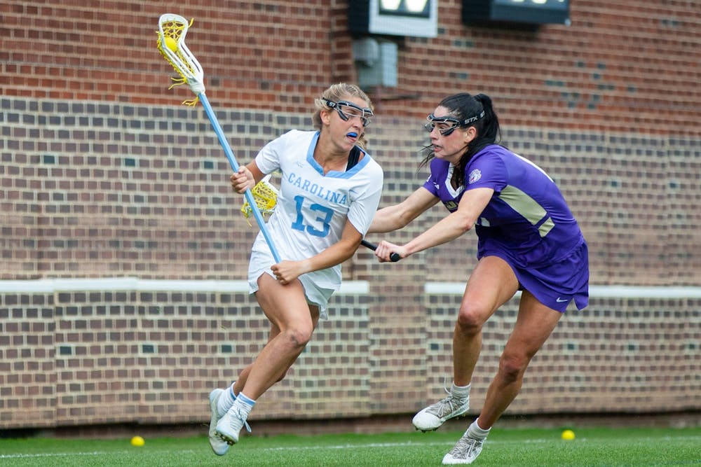 UNC first-year attacker Caitlyn Wurzburger (13) runs with the ball at the second round of the NCAA tournament against James Madison on Sunday May 16, 2021 at the Dorrance Field in Chapel Hill. The Tar Heels won 14-9.